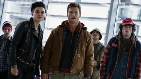 Katy O'Brian, Glen Powell, and Martin Herlihy as Laughlin, Ben Richards, and Jansky in The Running Man