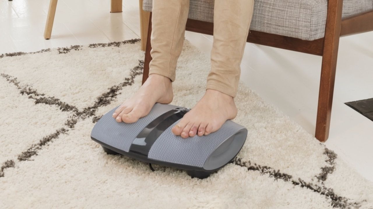 Person&#039;s feet on the Homedics Dual Shiatsu Foot Massager with Heat