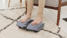 Person's feet on the Homedics Dual Shiatsu Foot Massager with Heat