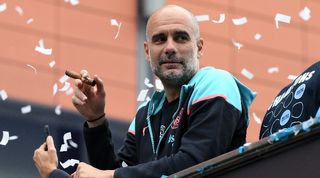 Pep Guardiola smokes a cigar during Manchester City's bus parade to celebrate their Premier League title in May 2024.