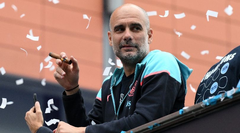 Pep Guardiola smokes a cigar during Manchester City&#039;s bus parade to celebrate their Premier League title in May 2024.