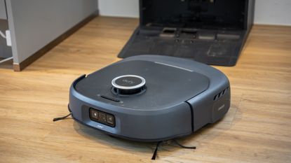 Eufy Omni E35 vacuum cleaner emerging from dock