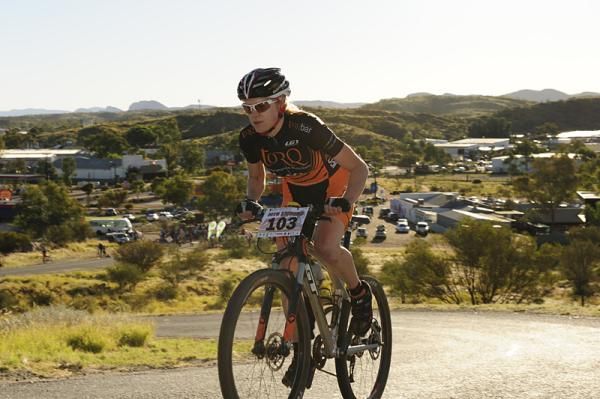 A Torq team racer climbs a hill in Alice Springs