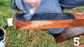 Painting bottom of fence post with Bitumen paint