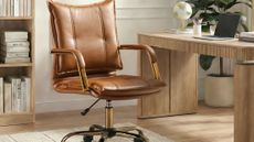 Cognac leather-and-brass office swivel chair styled in a study alongside a neutral wooden desk and bookshelf