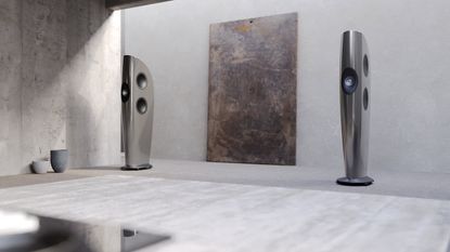KEF Blade One Meta speakers in the grey "grigio" finish in a very light coloured room with an abstract painting between them