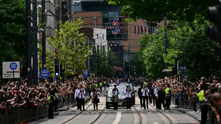 Mourners and music fans line the streets to pay their respects as the funeral cortege of Ozzy Osbourne, the late lead singer of Black Sabbath, makes its way through Birmingham, central England on July 30, 2025.