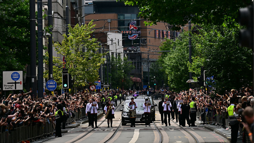 Mourners and music fans line the streets to pay their respects as the funeral cortege of Ozzy Osbourne, the late lead singer of Black Sabbath, makes its way through Birmingham, central England on July 30, 2025.