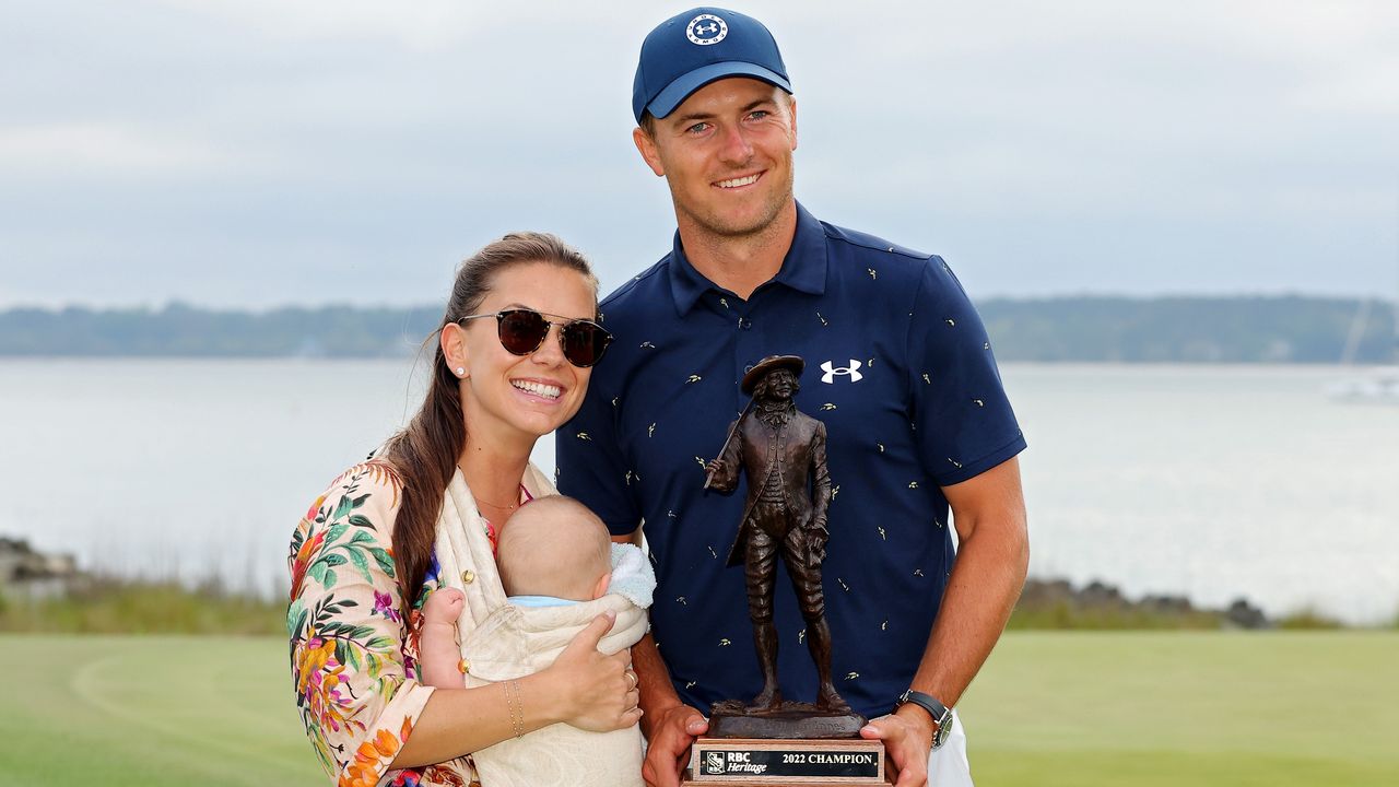 Jordan Spieth poses with the RBC Heritage trophy alongside wife Annie Verret and son Sammy