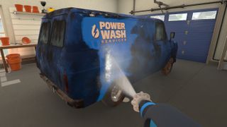A dirty blue van being power washed