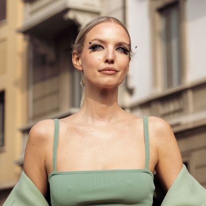 How to apply false eyelashes - woman photographed on the street with elaborate feathery false eyelashes - getty1469005529