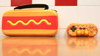 The Hyperkin Pixel Art hot dog controller next to its matching case
