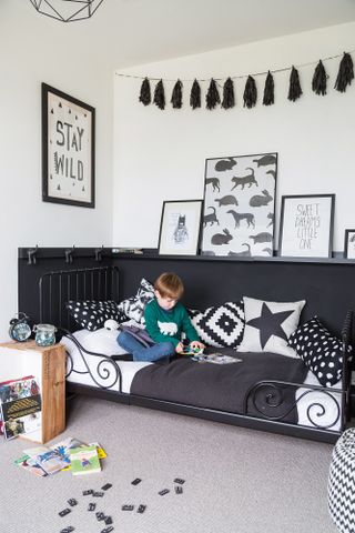 monochrome boys bedroom with animals decor and painted panelling