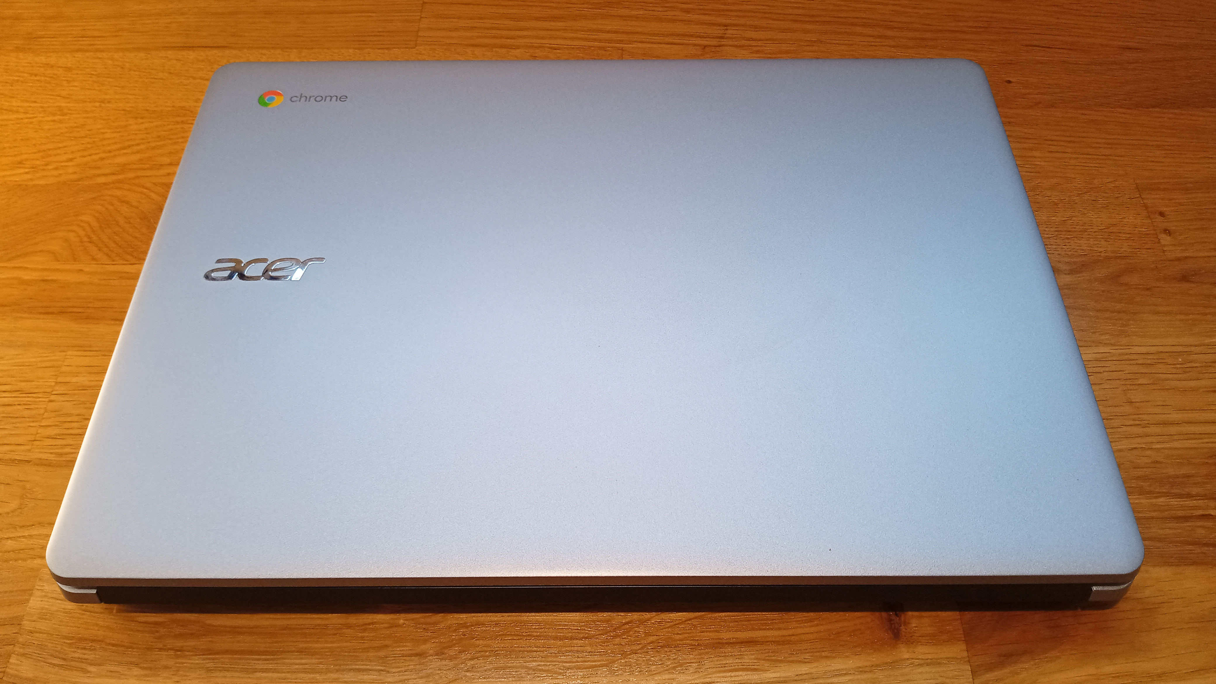 Acer Chromebook 314 review, a laptop on a wooden table with the lid closed.