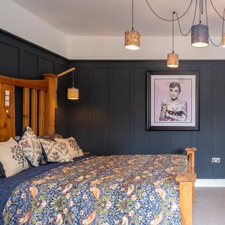 bedroom with inky blue panelled walls