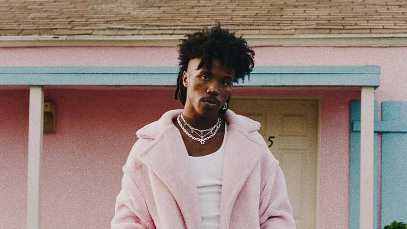 De&#039;Wayne in a pink fur coat outside a pink house
