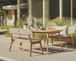 A garden terrace with long outdoor dining chair bench decor