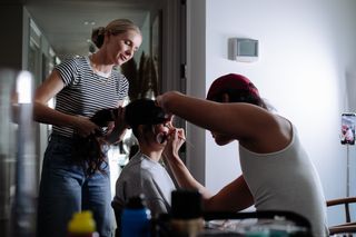 Nina Dobrev has her hair and makeup done in her hotel while getting ready for the carolina herrera show