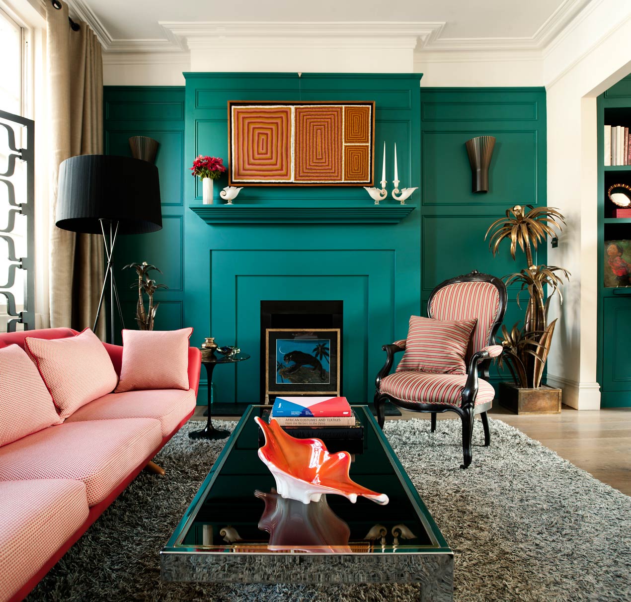 teal green living room with pink sofa by Maddux Creative