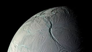 A close up of a gray planet with various streaks and ditches in its surface. 