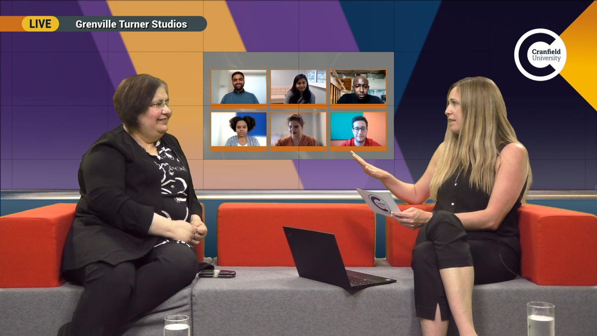 Two smiling women sit on couches conducting an interview with six people on a videoconference call thanks to NDI and the NewTek TriCaster,