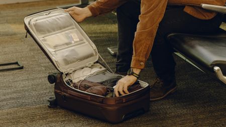 Peak Design Roller Pro roller case on the floor of luxury airport, opened out