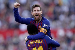 Lionel Messi celebrates with Ousmane Dembele after scoring for Barcelona against Sevilla in February 2019.