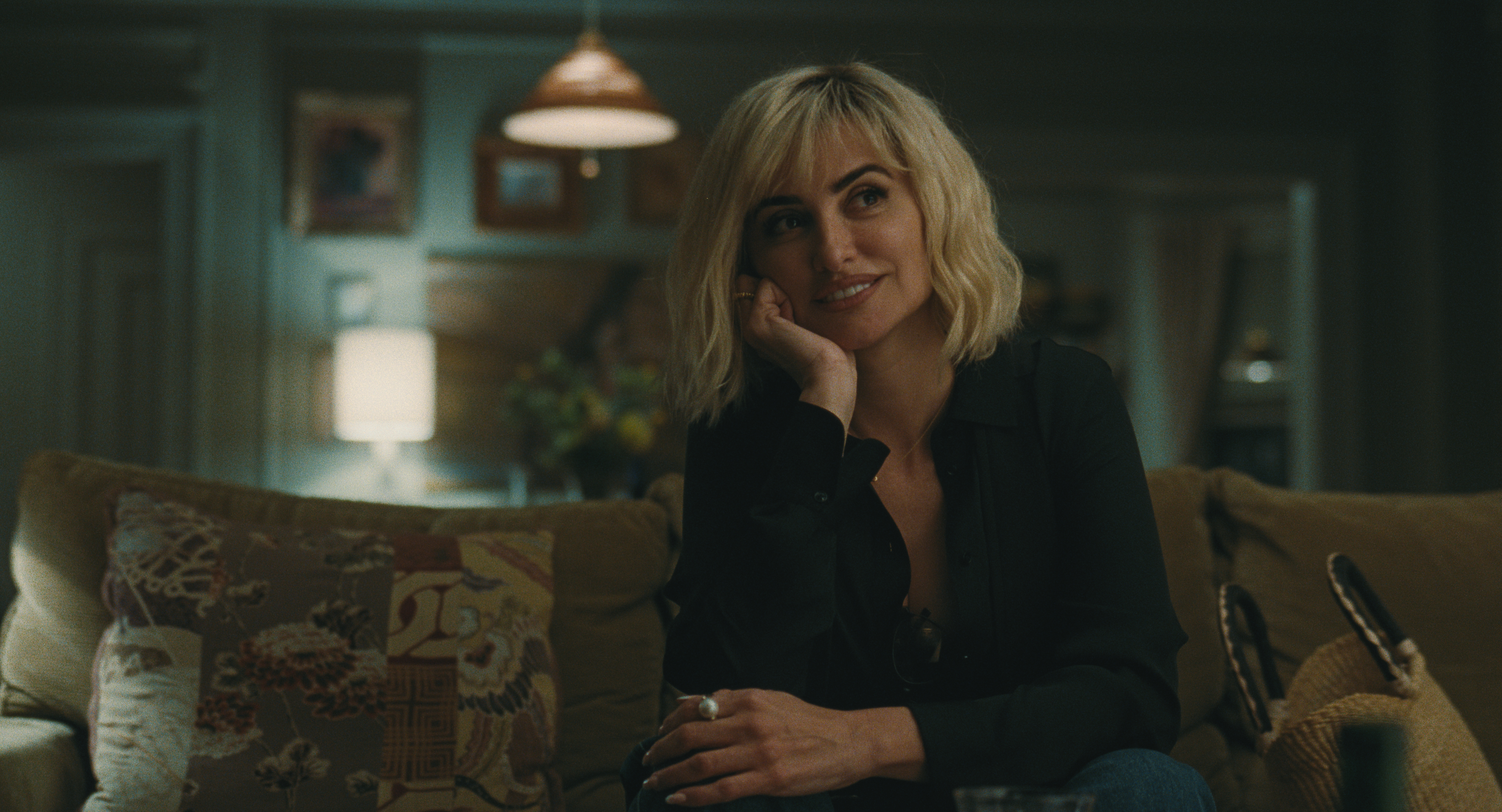penelope cruz as pina sitting on a couch resting her head on her hand in the movie the invite