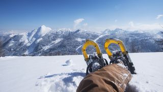 Picture of a hiker’s snowshoes as he kicks back and enjoys the mountain views