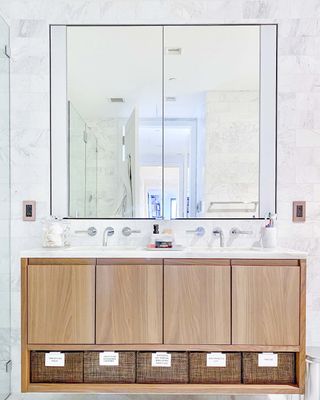 a vanity with labeled baskets underneath