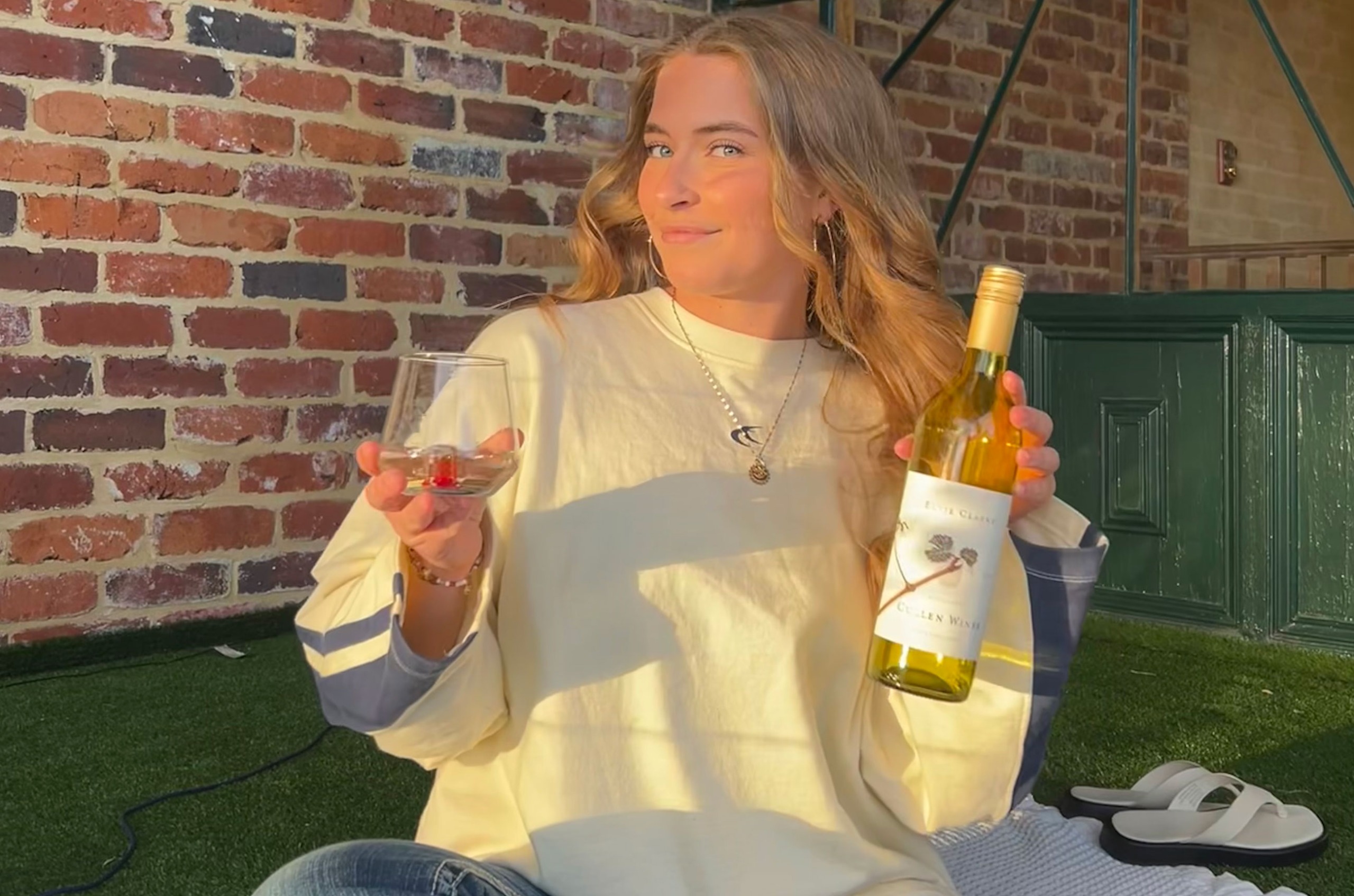 Taela-Leigh Walker with glass and bottle of Cullen Wines, Elvie Clarke 2024