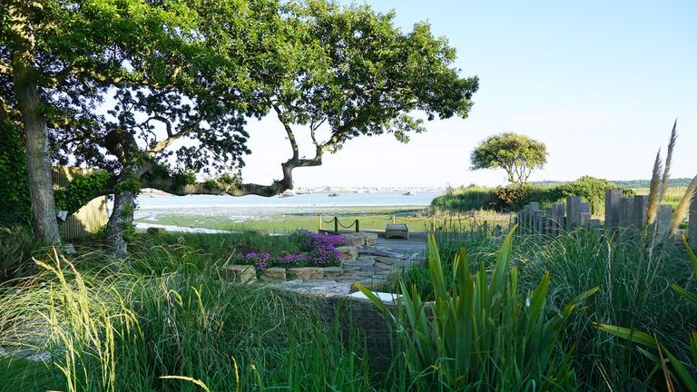 coastal garden design with paved area and grasses