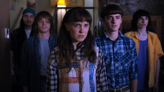 Eleven, Mike, Will and friends stare into the distance in an official image from Stranger Things season 4
