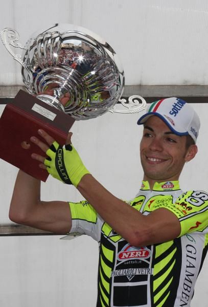 Italy's Giovanni Visconti (ISD) raises the GP Prato winner's trophy.