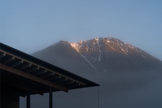 Corner of roof against mountain backdrop