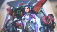 A promotional screenshot of the new Overwatch hero D.Mon. A Korean woman in a purple futuristic pilot suit stands tall in front of her large mech.