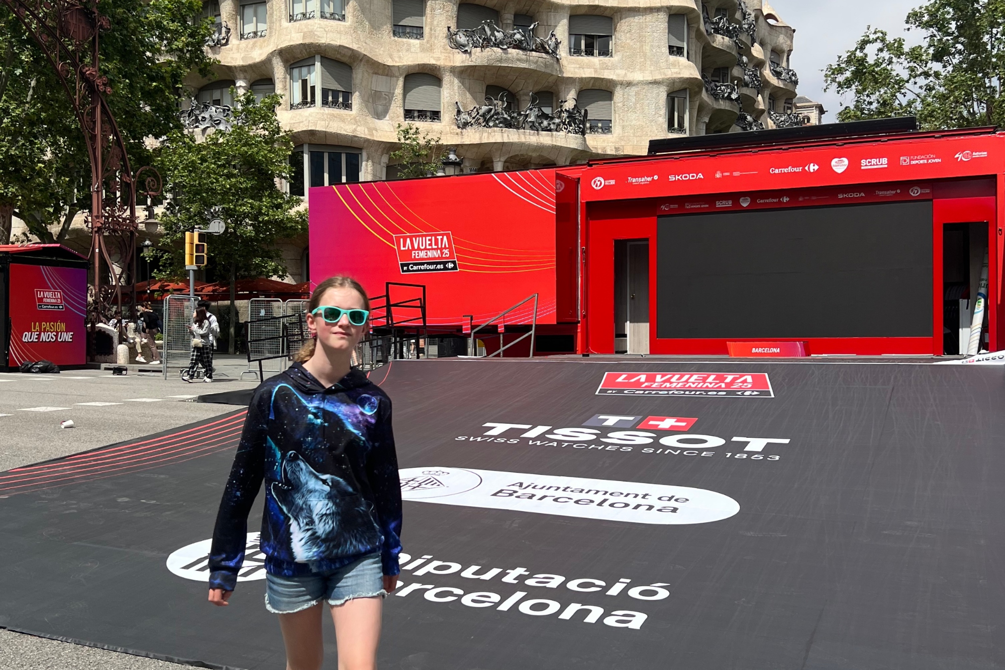 A girl stands at the bottom of a time trial start ramp of a grand tour cycle race