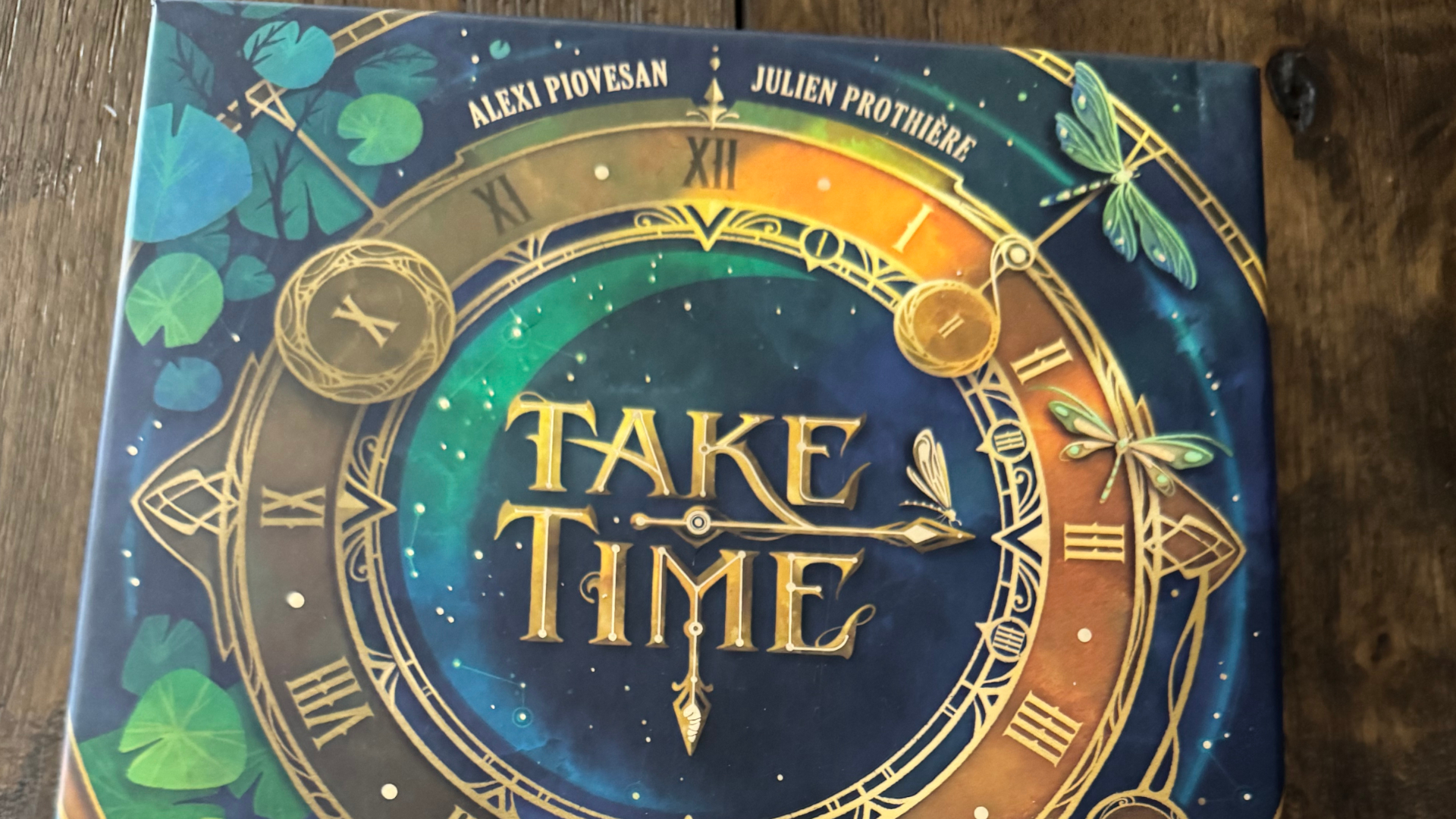 Take Time box depicting an ornate clock on a wooden table