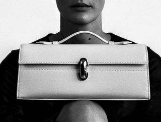 A model with a white east west bag by Savette