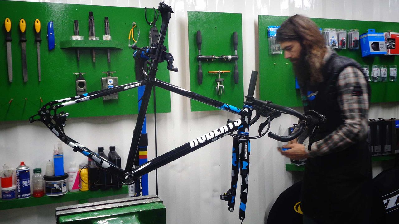 Eightbike being prepared by mechanic Glen Whittington on a workstand