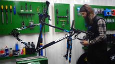 Eightbike being prepared by mechanic Glen Whittington on a workstand