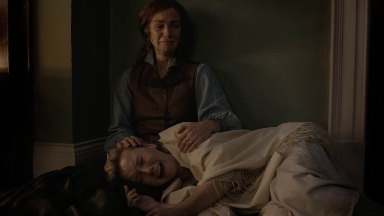 Brianna crying and holding Marsali while she sobs in the Outlander Season 8 trailer