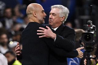 Manchester City's Spanish coach Pep Guardiola and Real Madrid's Italian coach Carlo Ancelotti hug each other at the end of the UEFA Champions League knockout phase play-off football match between Real Madrid CF and Manchester City at the Santiago Bernabeu stadium in Madrid on February 19, 2025. (Photo by JAVIER SORIANO / AFP) (Photo by JAVIER SORIANO/AFP via Getty Images)
