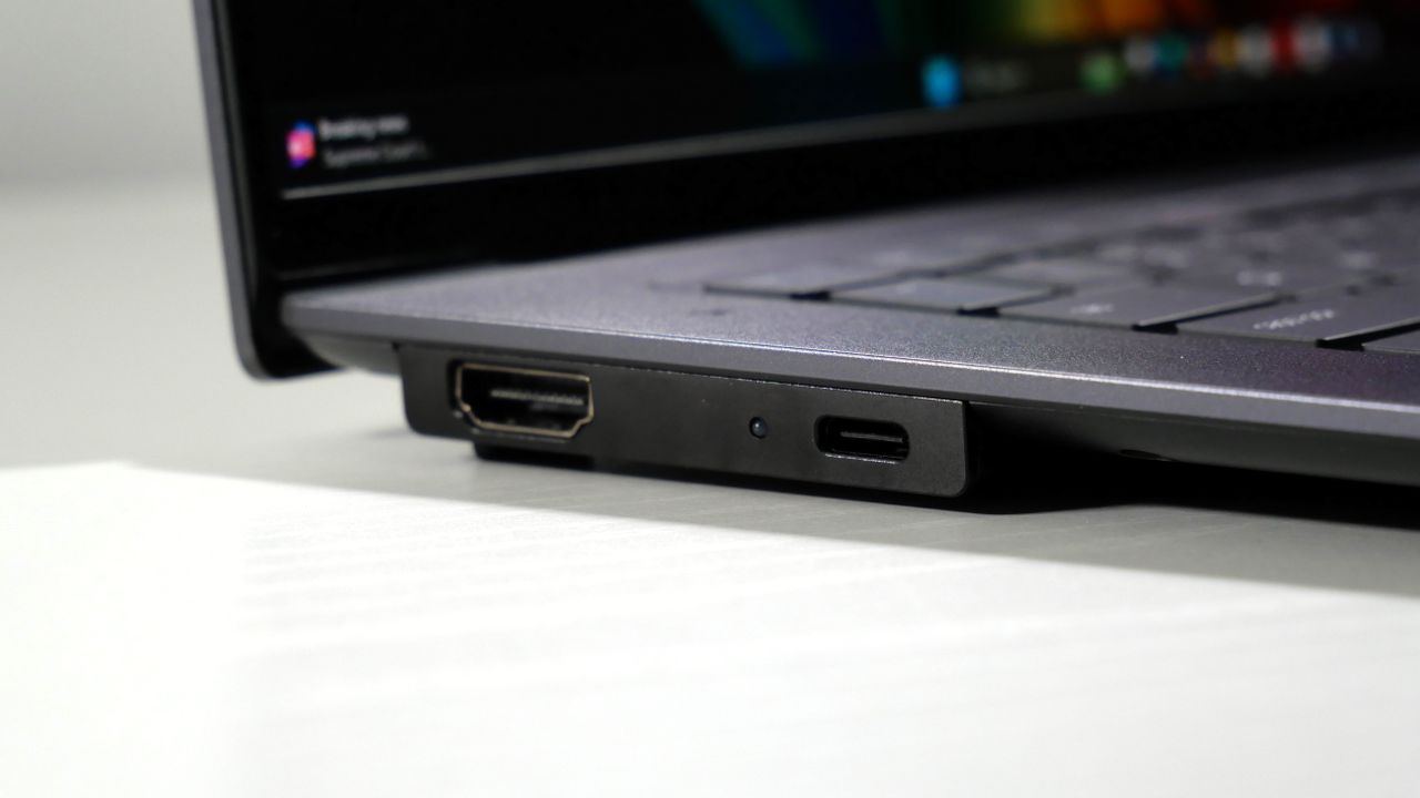 Lenovo ThinkPad X9-15 Gen 1 Aura Edition open on a white desk, highlighting the ports on the left.