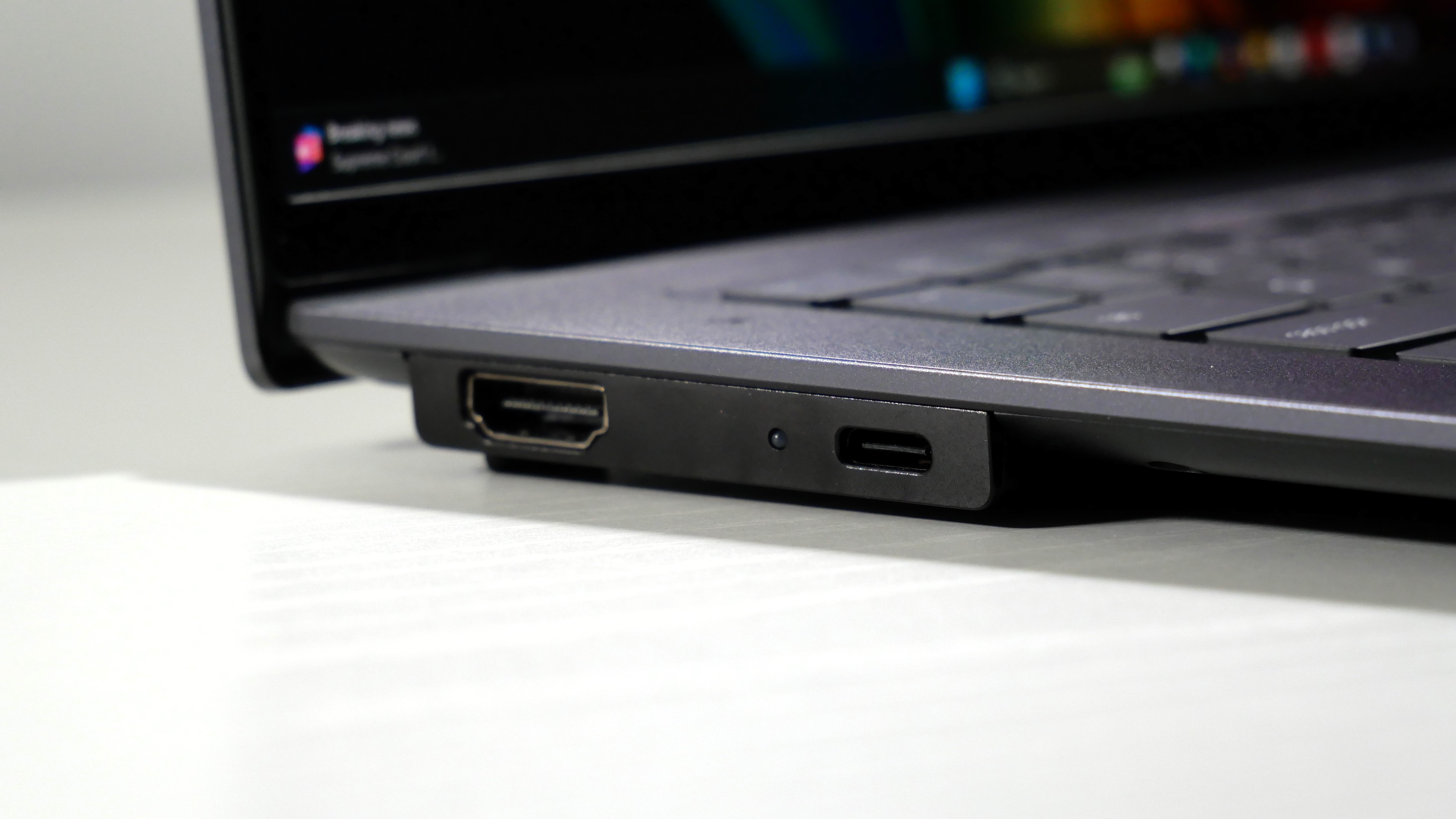 Lenovo ThinkPad X9-15 Gen 1 Aura Edition open on a white desk, highlighting the ports on the left.