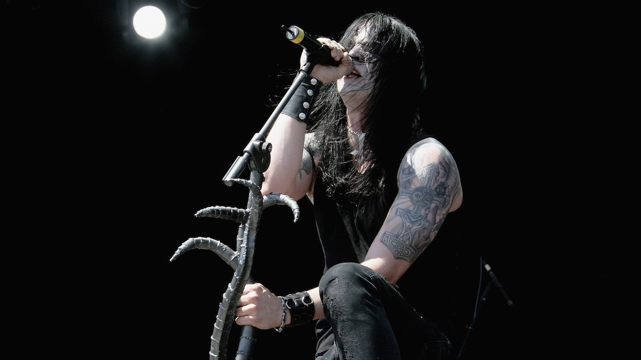 Satyr of Satyricon singing into a mic and holding the mic stand