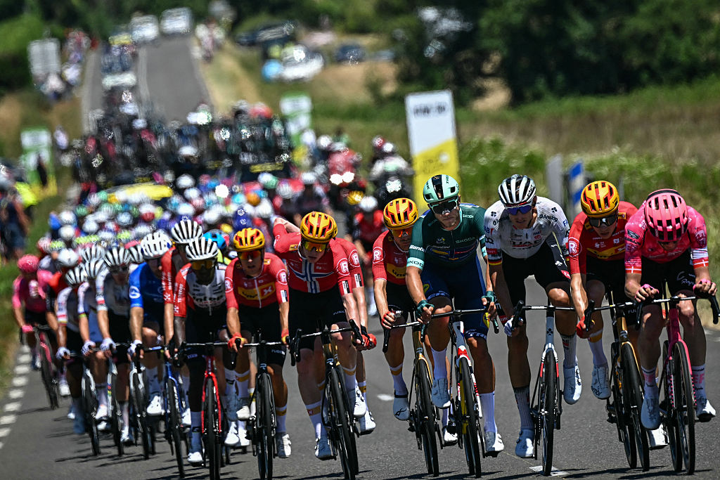 Uno-X Mobility team's Norwegian rider Andreas Leknessund (C) cycles ahead of the pack of riders (peloton) alongside Lidl - Trek team's Italian rider Jonathan Milan wearing the best sprinter's green jersey (4th R) and UAE Team Emirates - XRG team's German rider Nils Politt (3rd R) during the 12th stage of the 112th edition of the Tour de France cycling race, 180.6 km between Auch and Hautacam, in the Pyrenees mountains of southwestern France, on July 17, 2025. (Photo by Loic VENANCE / AFP)