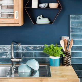 kitchen with navy blue wall and metro tiles with bowls