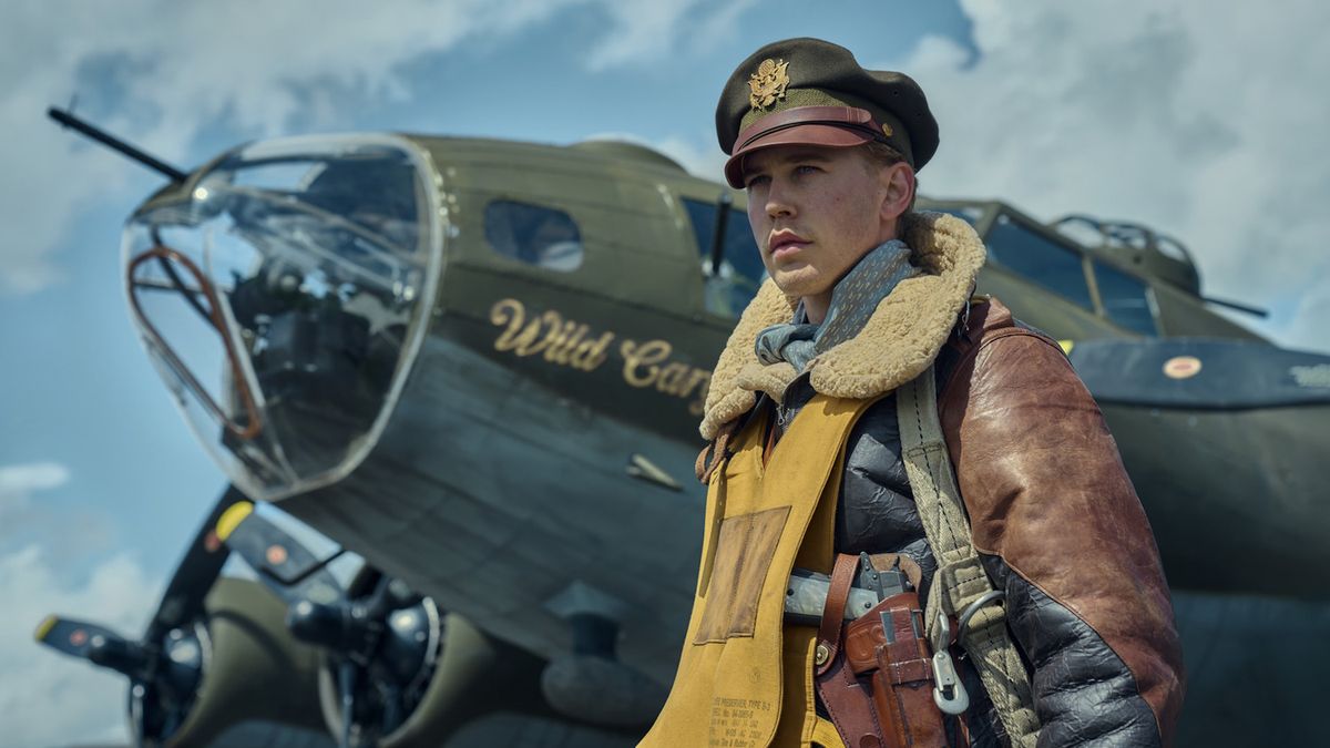 Austin Butler as Major Gale Cleven standing in front of a WWII fighter jet in a promotional shot for Masters of the Air