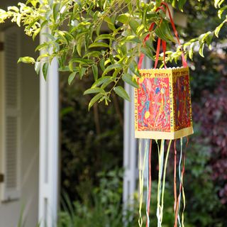 garden with green trees with hanging red pinata